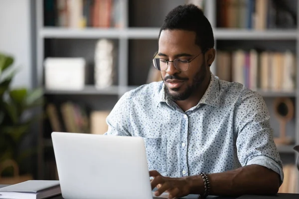 Busy african man freelancer do remote work using laptop — Stock Photo, Image