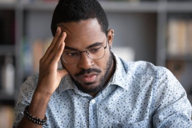 African businessman thinking of problem solution feels concerned