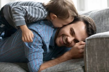 Close up happy loving father and adorable little son cuddling