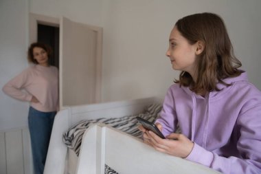 Worried mom control teenage daughter gadget use