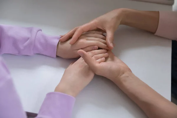 Close up of caring mom hold teen daughter hands — Stock Fotó