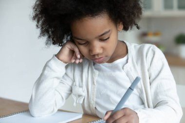 Disinterested in study african little schoolgirl do homework at home clipart