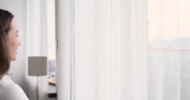 Smiling young lady watching cityscape, enjoying weekend time.