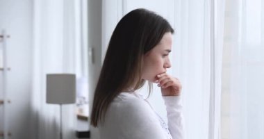 Upset worried young brunette woman thinking of problems.