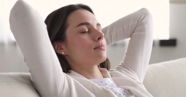 Refreshed attractive woman waking up after napping on cozy sofa. — Αρχείο Βίντεο