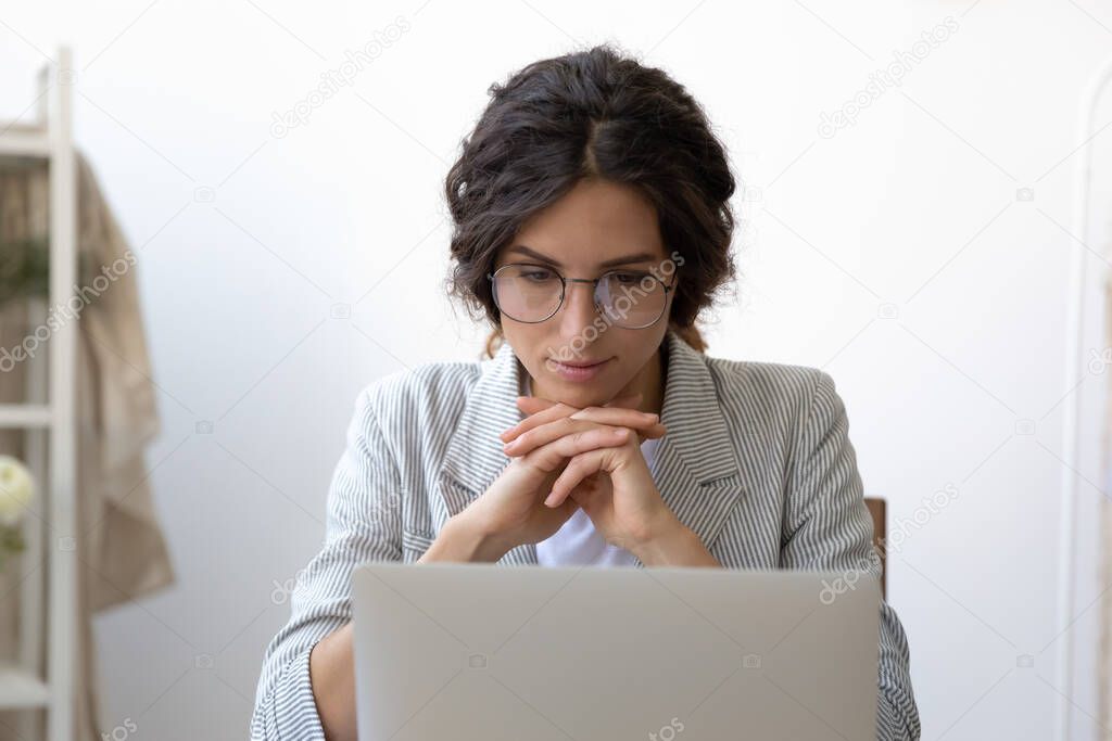 Young Caucasian woman watch webinar on laptop