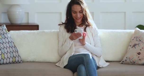 Happy young woman involved in social networks mobile communication. — Stock Video