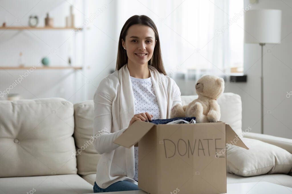 Woman prepare donation box with old stuff for charity