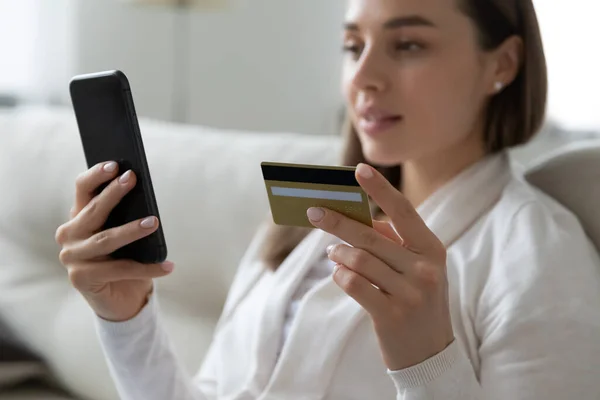 Mujer haciendo pago en línea con tarjeta de crédito y teléfono inteligente — Foto de Stock