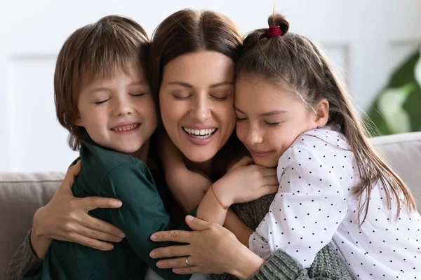 Head shot portrait happy mother hugging son and daughter — Stock Photo, Image