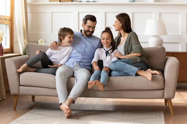 Glückliche Eltern mit Sohn und Tochter relaxen auf der Couch — Stockfoto