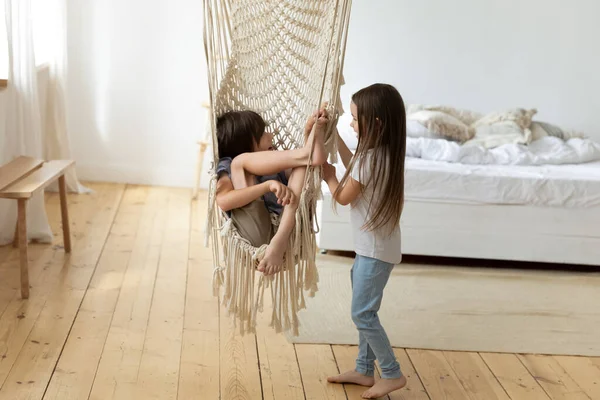 Happy little cute brother and sister playing with hammock. — Stok Foto