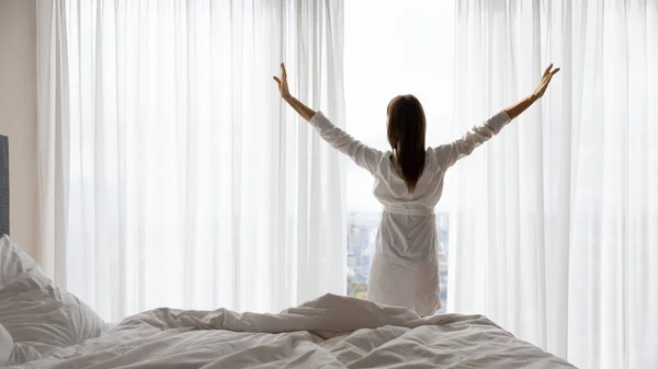 Happy young woman stretch in bed welcoming new day — Stok Foto