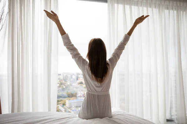 Back view of woman stretch in bed in morning — Stock Photo, Image