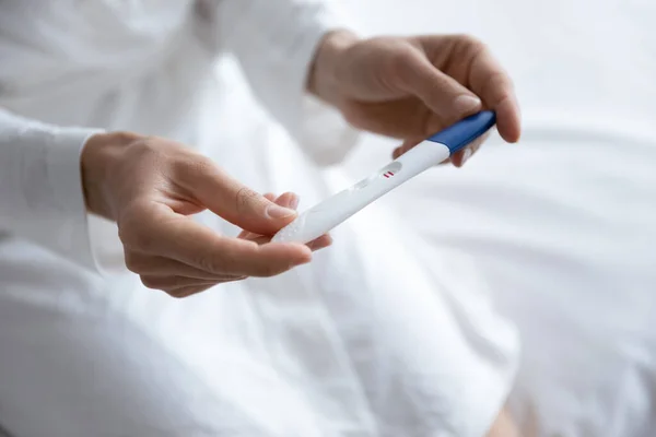 Close up of young woman do ovulation test at home — Stock Photo, Image