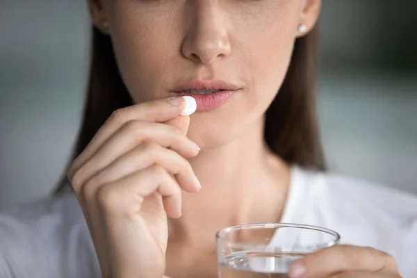 Anxious young woman feel unwell taking pill — Stock Photo, Image