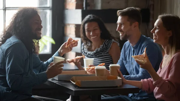 Friends sitting in cafe eat pizza drink coffee enjoy communication