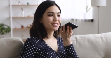 Vietnamlı kadın hoparlörden erkek arkadaşıyla akıllı telefon kullanıyor.