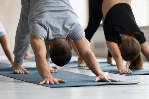Young healthy strong man standing in downward facing dog pose. — Stock Photo, Image