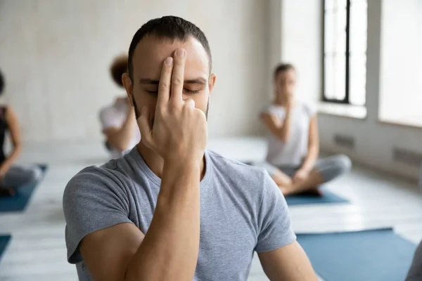 Mindful young man practicing Alternate Nostril Breathing. — Stock Photo, Image