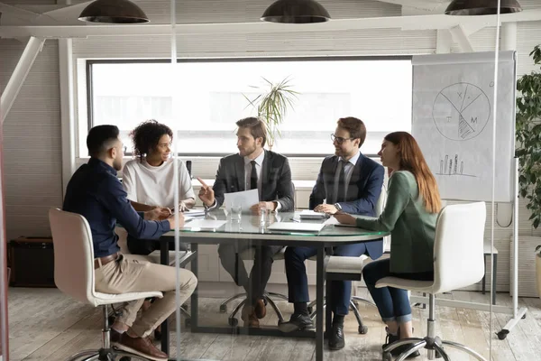 Empleados multiétnicos se reúnen en la sala de juntas para intercambiar ideas juntos — Foto de Stock