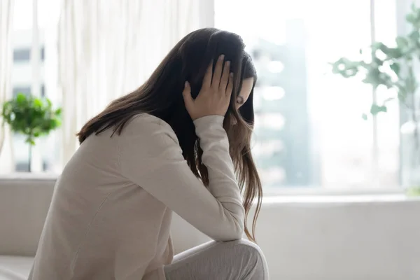 Unhappy depressed woman sitting alone, thinking about problems — Stock Photo, Image