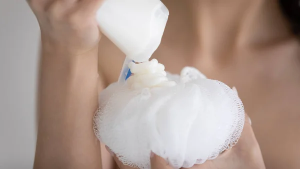 Close up woman applying shower gel on white bath puff — Stock Photo, Image