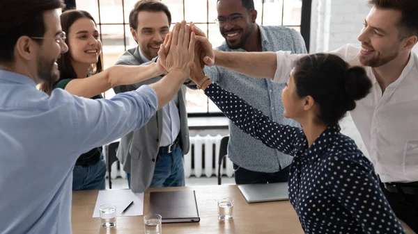 Excited multiethnic staff members giving high five sharing success — Stock Photo, Image