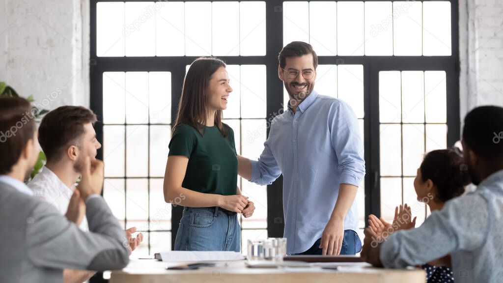 Promoted female employee receive congrats from company staff