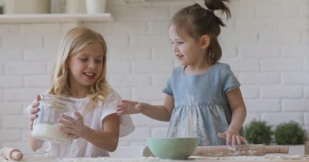 Glücklich entzückende Kinderschwestern genießen das gemeinsame Kochen beim Zubereiten von Teig — Stockvideo