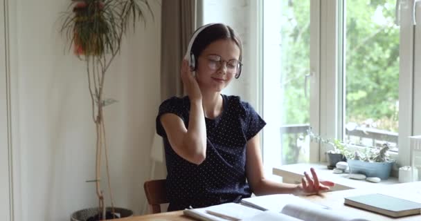 Girl wear headphones distracted from study listen classic music — Stock Video
