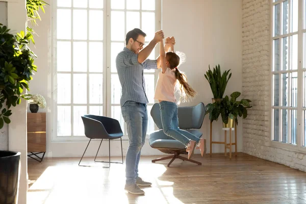 Loving father holding little daughter hands, having fun at home — Stock Photo, Image