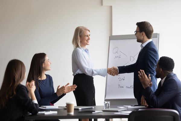 Mature client executive manager shaking hands greeting each other
