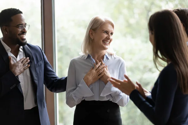 Middle-aged businesswoman get congrats and compliments from multiethnic colleagues — Stock Photo, Image