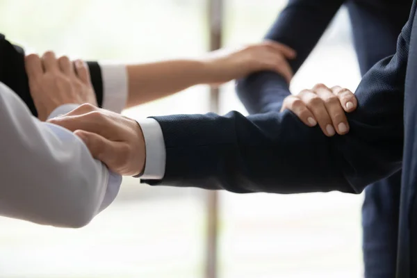 Businesspeople standing shoulder by shoulder showing unity closeup image — Stock Photo, Image