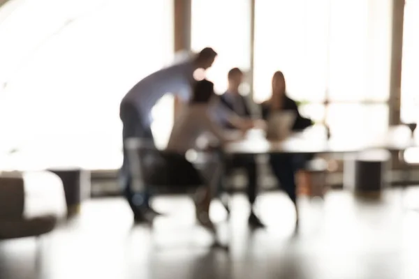 Blurry view of colleagues work together on project in office — Stock Photo, Image