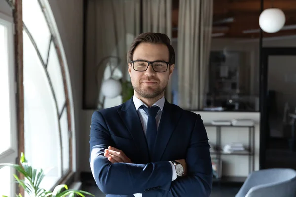 Profile picture of confident businessman posing at workplace