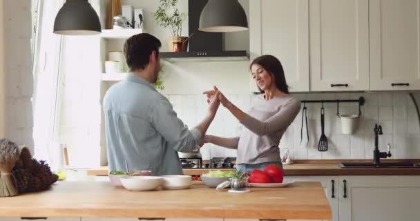 Casal de mãos dadas dançar desfrutar de data romântica na cozinha — Vídeo de Stock