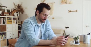 Milenyum çocuğu elinde akıllı telefon tutuyor. Harika haberler okuyor. Çok mutlu.