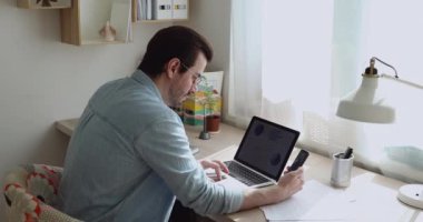 Akıllı telefon kullanan adam ekran analizlerine bakıyor.