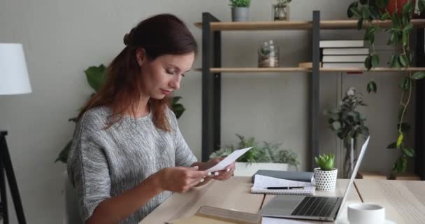 Kvinna tar ut brev från kuvert läsa trevliga nyheter — Stockvideo