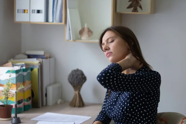 Unhealthy young woman touch neck suffering from pain — Stock Photo, Image