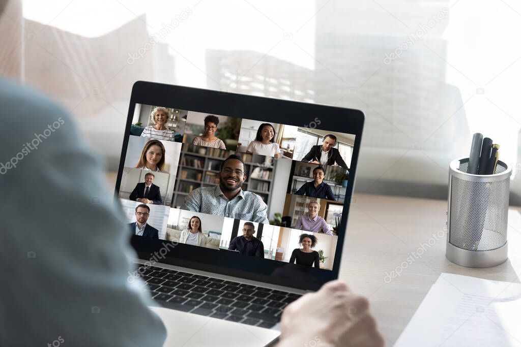 Back view of male employee have webcam conference with colleagues