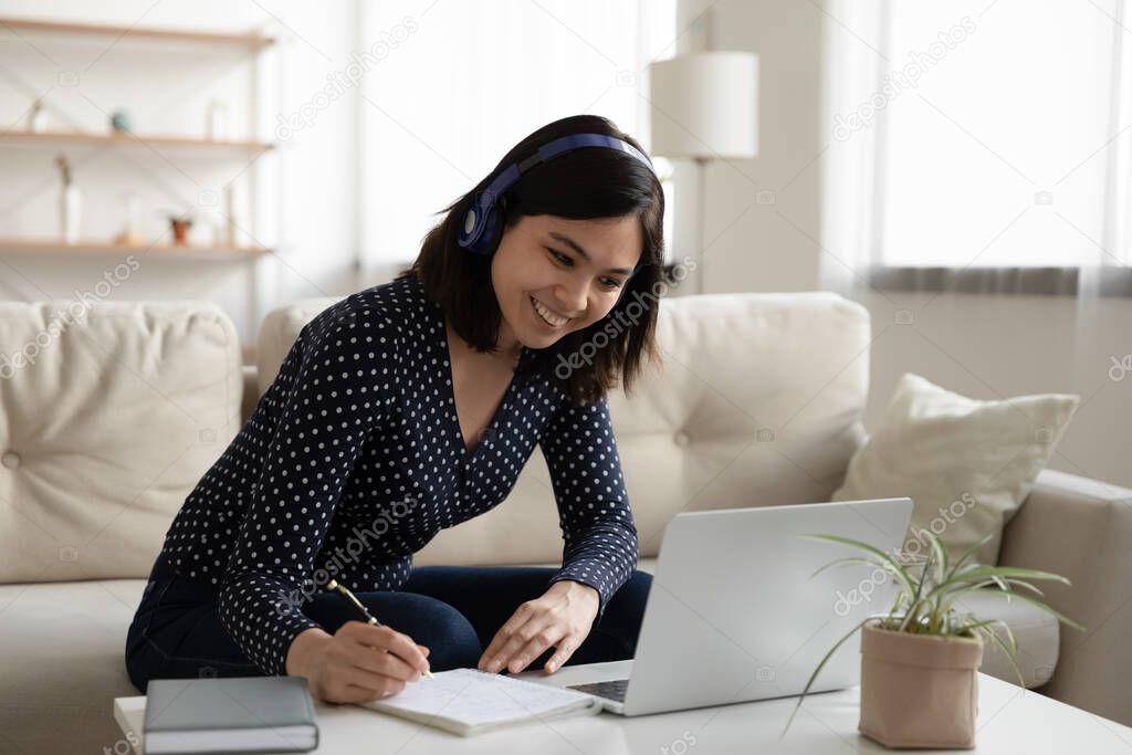 Smiling Asian girl study online on laptop