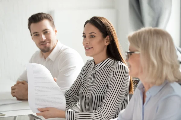 Businesswoman holding document, sharing ideas at business briefing