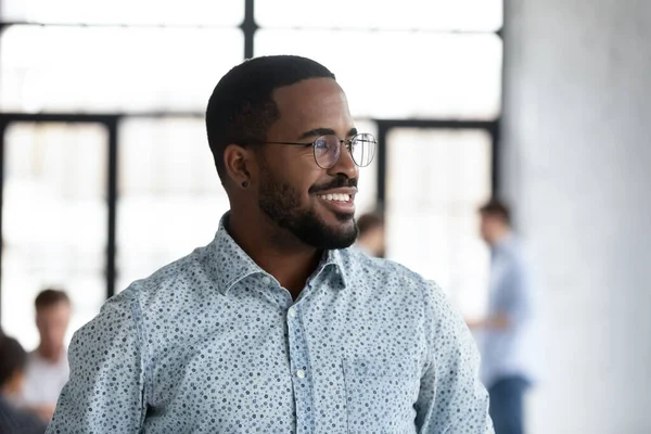 Närbild leende drömmande afroamerikansk affärsman tittar åt sidan — Stockfoto