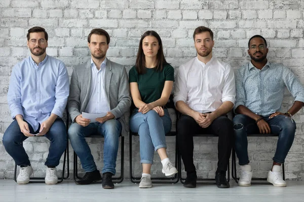 Portrait confident diverse candidates sitting in row, waiting for interview — Stock Photo, Image