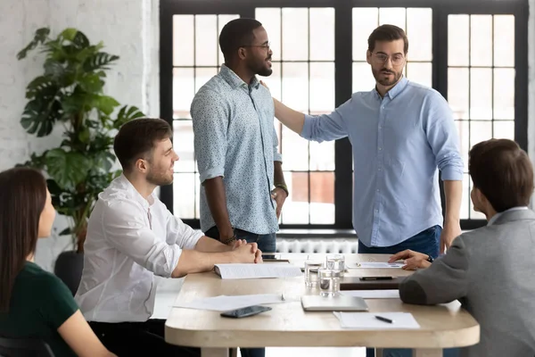 Executive introducing new African American employee to colleagues — Stock Photo, Image