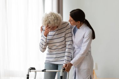 Depresyondaki engelli kadını destekleyen profesyonel kadın fizyoterapist..