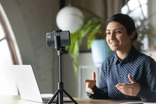 Skilled confident indian woman recording educational business lecture.